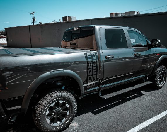 2022 RAM Crew Cab with AMP Research Power Steps and a Bakflip MX4 Tonneau Cover at Dealer Source Ltd in San Antonio, Texas